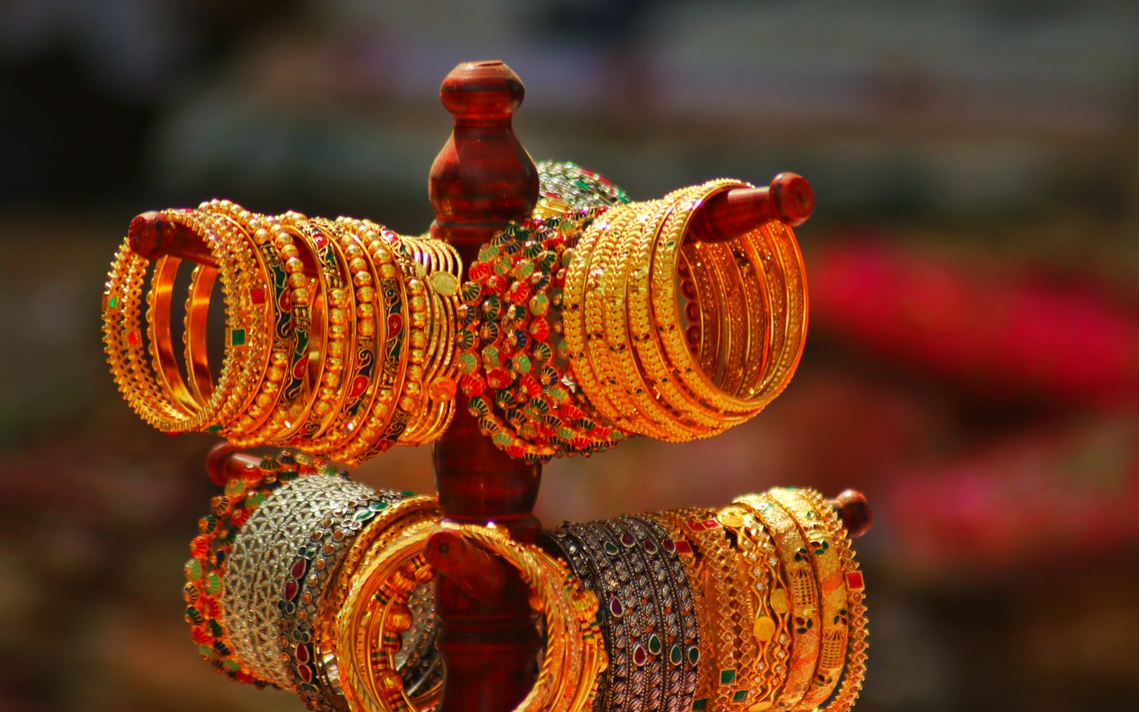 Gold-finish bangles displayed on a stand